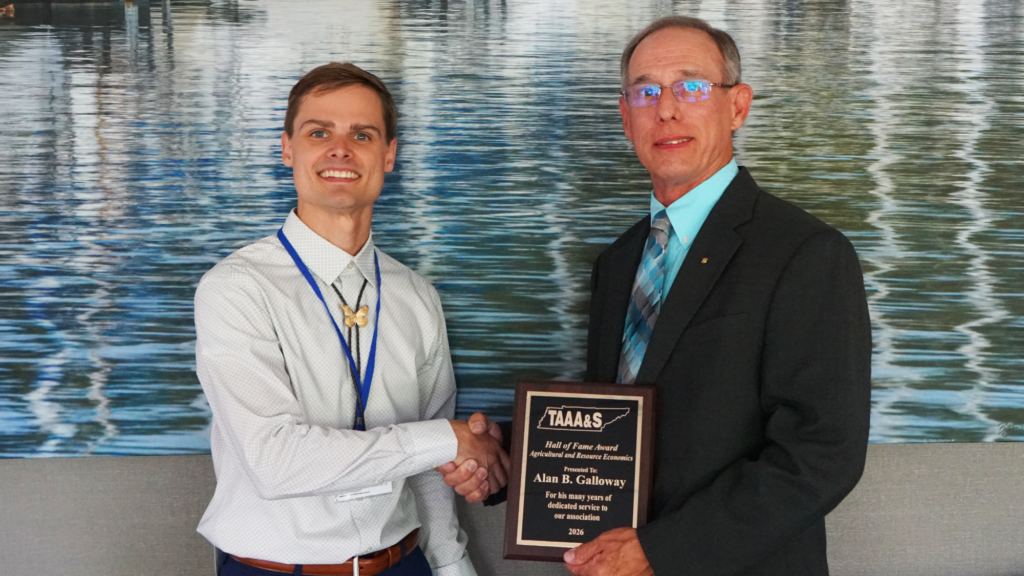 2026 Hall of Fame Award winner holding plaque